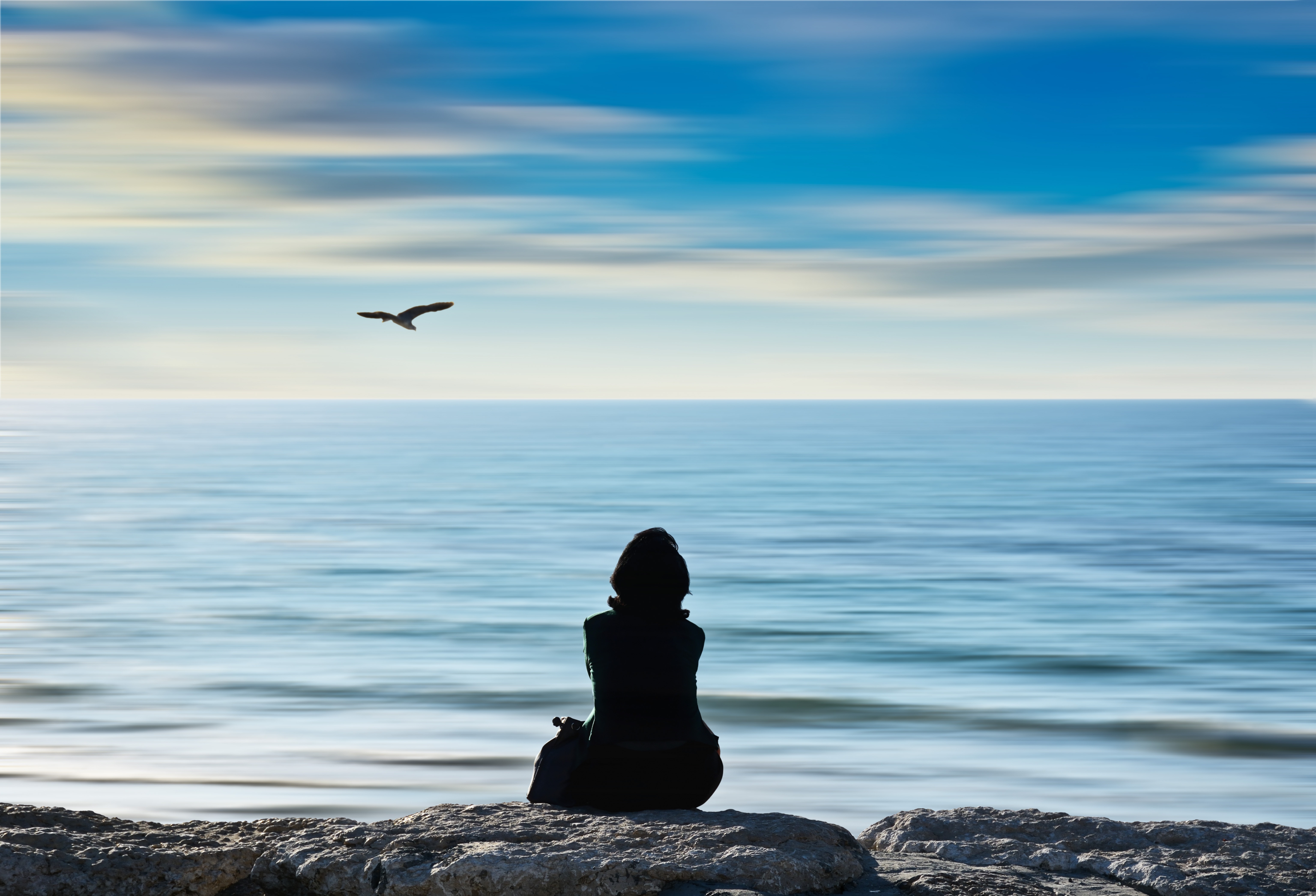 woman looking out at ocean